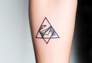 Small geometric triangle with a geometric paper plane going around the world with thin fine lines tattoo idea