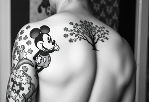 Autism full left arm sleeve including Mickey Mouse and a tree at the start with autism puzzle pieces everywhere tattoo idea