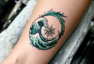 A deep sea green wave with frothy white caps encircles a compass rose on the forearm. tattoo idea