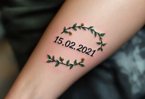 Luky name 15. 02. 2021 – Deep emerald green vine twisting around Lucas's birthdate, with small yellow blooms dotting the numbers. tattoo idea