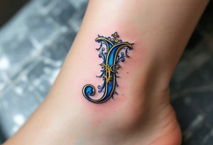 Ornate gold "J" with baroque-style filigree details and royal blue shading. tattoo idea