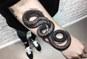 a tattoo of a writhing snake on a forearm tattoo idea