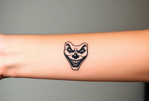 poker joker face in bad clown mask tattoo idea