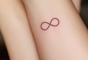 Three different infinity symbols in gold, silver, and rose gold, each person (three) has its own tattoo idea