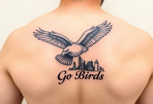 Tattoo On upper bicep 
Philadelphia Eagle classic bird flying over Philadelphia city skyline with the words Go Birds under it tattoo idea