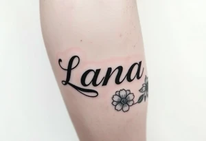 the name Lana going from my knee to my ankle the back of my leg with some flowers tattoo idea