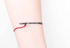 chinese chopsticks with a red thread by the end of it,
about 5cm long , 1 cm wide
it goes into the anterior part of the left wrist tattoo idea