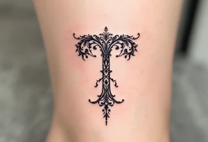 A delicate lace-like "T" in faded charcoal with a vintage feel. tattoo idea