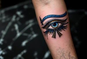 A blue and bronze Eye of Horus, detailed with ancient lines, placed on the forearm for protection and healing. tattoo idea