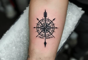 Rustic half compass with a long native American arrow pointing at my wrist with the words “True North” tattoo idea