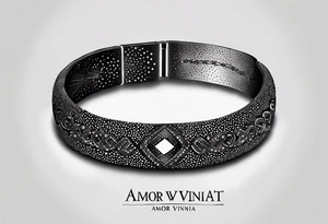 words "amor vincit omnia" shaped like a bracelet tattoo idea