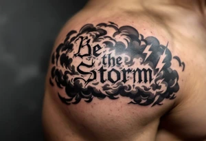 "Be the Storm" in sharp serif font, black ink with storm cloud shading and lightning bolt details in gray. tattoo idea