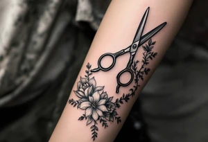 large haircutting scissors going from wrist to elbow with large flowers and vine woven around up and down the arm tattoo idea