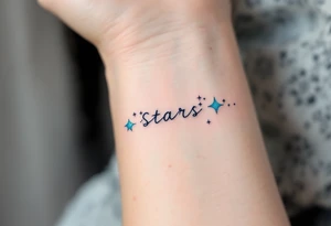 A quote in icy blue ink crosses the wrist with a constellation pattern forming the final word: Stars. tattoo idea