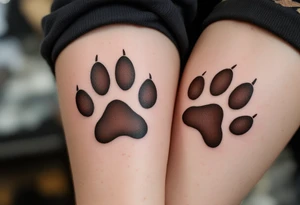 Coordinated matching paw prints in rich brown ink reflect a shared love for pets and loyalty. tattoo idea