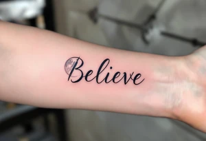 The word "Believe" in gray, with moon phases in the background, conveying the cyclical nature of life and faith in change. tattoo idea
