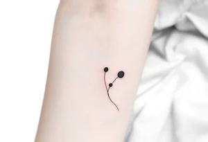 Three charcoal black dots tattoo idea
