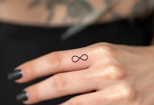 A rose band on finger with a small infinity symbol tattoo idea