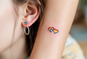 Tiny matching rainbow hearts behind ear of each partner to honor love in every shade. tattoo idea