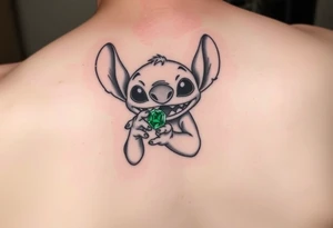 Stitch holding emerald birthstone for forearm tattoo idea