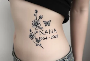 flowers and butterflies with the name “NANA” and the date “1954-2022” mixed all together on the side of the rib cage tattoo idea