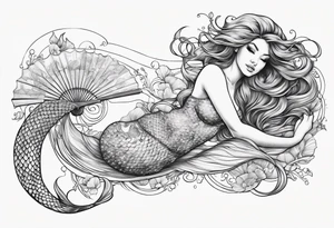 mermaid lying on her back with flowing hair and fan tail tattoo idea