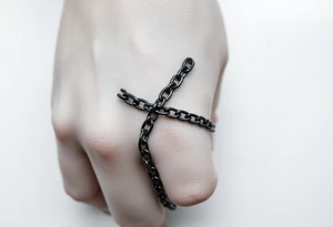 Gothic chains wrapped around outline of the index finger and connected to the thumb tattoo idea