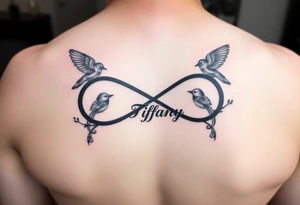 Infinity symbol with birds and the name Tiffany attached to the symbol tattoo idea
