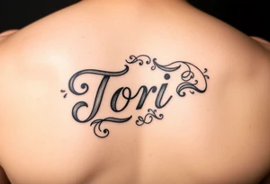 The name Tori on a man’s hand with designs tattoo idea