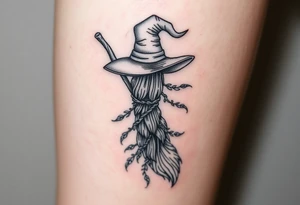 Which is broom with a witches hat with vines and feathers on your leg 
Smaller broom with hat placed on top or in the middle tattoo idea