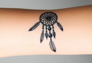 native dreamcatcher with flowing feathers and sacred beads tattoo idea