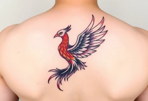 Phoenix with purple red and yellow color located on the lower back tattoo idea