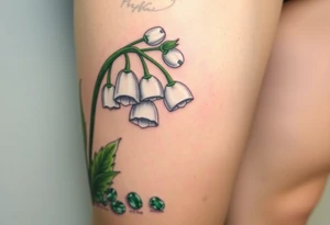 White lily in the valley bells with emeralds on the ground next to the plant tattoo idea