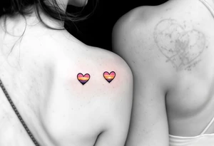 Tiny hearts shaded with a sunset gradient of orange, pink, and purple across each partner shoulder blades. tattoo idea