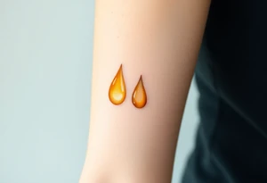 A pair of teardrops cascading from the eyes, in shades of golden yellow and pale peach, symbolizing the quiet release of grief tattoo idea