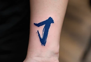 Brushstroke-style "J" in deep indigo, resembling Japanese ink calligraphy. tattoo idea