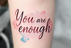 “You are enough” in dusty rose with a faint watercolor background of pastel blues and pinks. tattoo idea