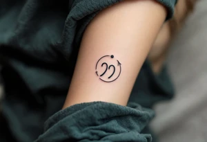 A comma with a dot above it, with an arrow around tattoo idea