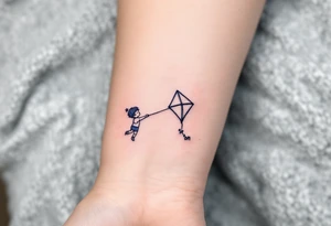 A line-art drawing of a child flying a kite, with the kite string forming the son’s name in dark navy ink. tattoo idea