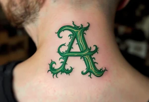 A calligraphy "A" in emerald green with fine golden flourishes. tattoo idea