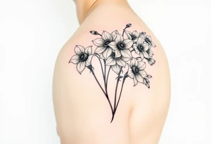 realistic daisies, daffodils, lily of the valley covering bicep for woman tattoo idea