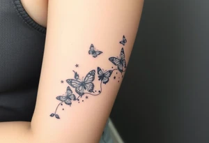 Butterflies streaming down arm with kid names (Aden, Aninna, Novaih, Jayla, Rayla ) in between them with a streamer binding them together tattoo idea