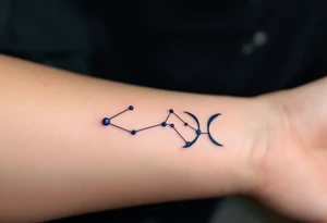 A bold constellation in sapphire ink arcs over a pale Pisces glyph, creating a celestial connection on the wrist. tattoo idea