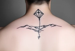 Kite in the country hand holding a kite. Over the hills tattoo idea
