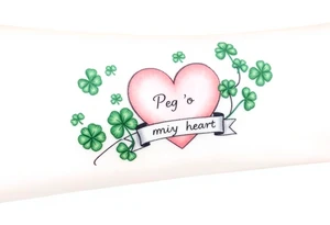 A ton of green shamrocks and a big pale pink heart with a banner across the heart that says Peg 'o My Heart tattoo idea