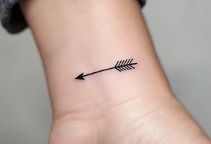 A sleek black ink arrow with a delicate gold accent running along its shaft, symbolizing elegance and direction. tattoo idea