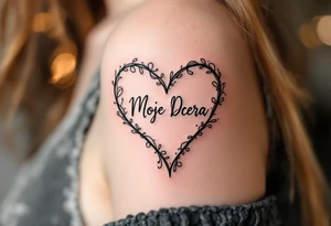 A delicate black and pink line-art heart with the word “Moje Dcera” written in elegant cursive across the center. tattoo idea