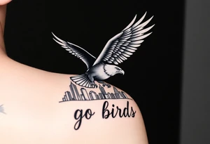 Philadelphia Eagle classic bird flying over Philadelphia city skyline with the words go Birds under it on bicep tattoo idea