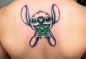 Stitch holding emerald birthstone for forearm tattoo idea