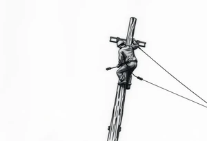 power lineman climbing a wooden 12kv pole. Make the pole a cross that has a hidden resemblance to god. tattoo idea